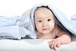 Baby after bath under a blanket