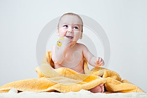 Baby After Bath Wrapped in Yellow Towel Sittin