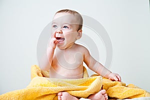 Baby After Bath Wrapped in Yellow Towel Sitting