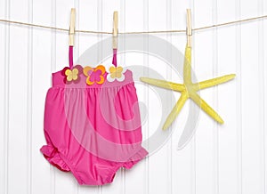 Baby Bathing Suit and Starfish on a Clothesline