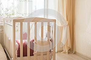 Baby bed crib with white and Burgundy color pillows with laces