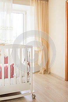 Baby bed crib with white and Burgundy color pillows with laces