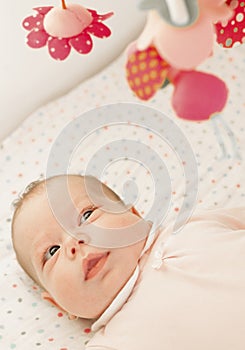 Baby in bed with toys