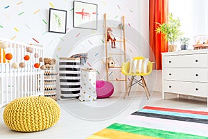 Baby bedroom with yellow pouf