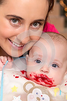 Baby with beetroot on his mouth