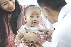 baby being checked by a doctor