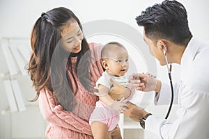 baby being checked by a doctor