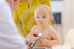 Baby being checked by doctor using stethoscope