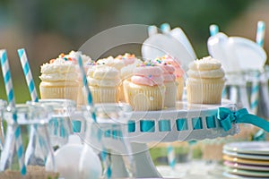 Baby birthday decoration with bottles of milk and cupcakes