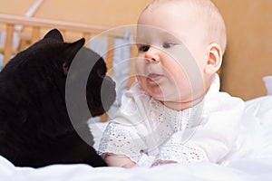 Baby with black cat