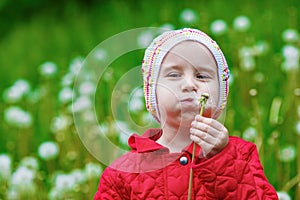 Baby blowing dandelion