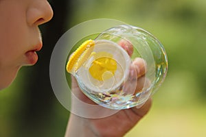 Baby blows a soap bubble