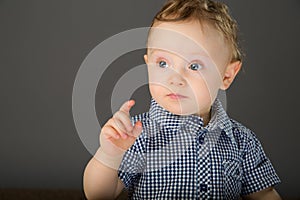 Baby in a blue checkered shirt