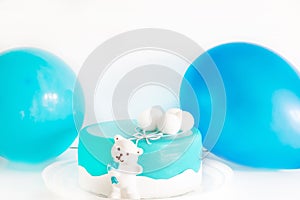 Baby blue delicious cake decorated with balloons for child's first birthday celebration. set with blue colors for baby