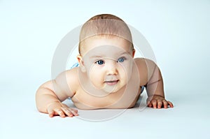 Baby with blue eyes lying on the background