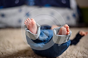 Baby in Blue Jeans Lying on the Floor