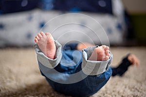 Baby in Blue Jeans Lying on the Floor