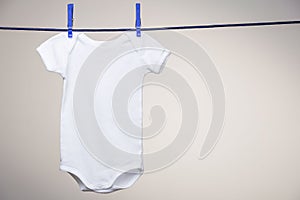 Baby bodysuit on clothesline