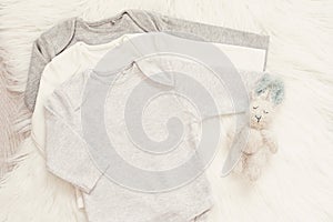 Baby Bodysuit Mockup. Styled Stock Photography. Clothes and Bunny Toy For A Boy. Jumpsuits, Rompers On A White Fur Carpet. Newborn