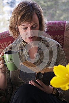 Baby boomer Mum taking a break and reading a book photo