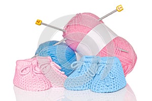 Baby booties with wool and knitting needles