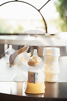 Baby bottle with milk and manual breast pump