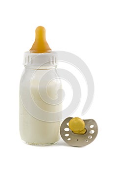 Baby bottle with milk and pacifier isolated