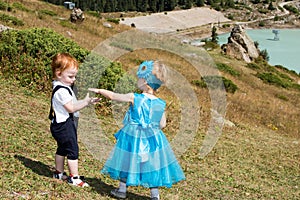 Baby boy and adorable child girl on grass. Summer green nature