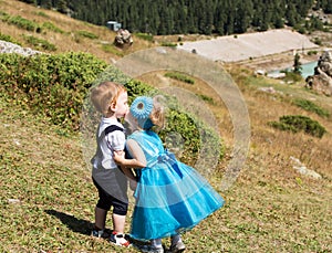 Baby boy and adorable child girl on grass. Summer green nature background.