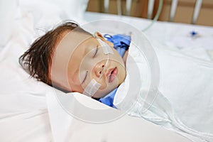Baby boy age about 1 year old sleeping on patient bed with getting oxygen via nasal prongs to assure oxygen saturation. Intensive