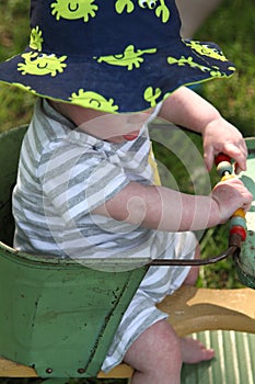 Baby boy in antique stroller outdoors on beautiful day