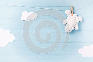 Baby boy background with white teddy bear toy on a clothesline and clouds