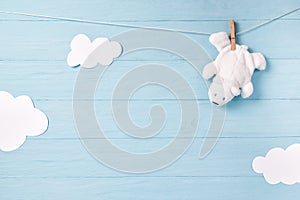 Baby boy background with white teddy bear toy on a clothesline and clouds