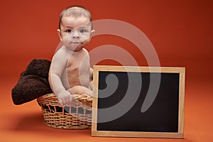 Baby boy in basket with clear board