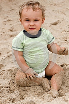 Baby boy on beach sand