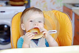 Baby boy biting round cracknel photo