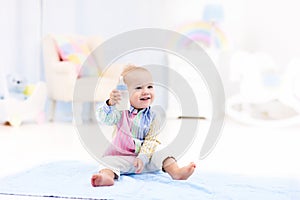 Baby boy with bottle drinking milk or formula