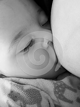 Baby boy breastfeeding in black and white