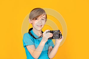 Baby boy with camera. Cheerful smiling child holding a cameras. Little boy on a taking a photo using a vintage camera