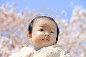 Baby boy and cherry blossoms