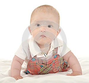 Baby boy crawling on blanket