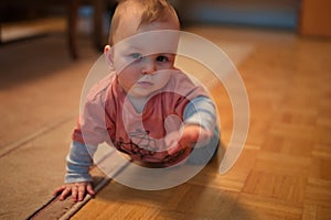 Baby boy crawling at home