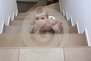 Baby boy crawling up the stairs