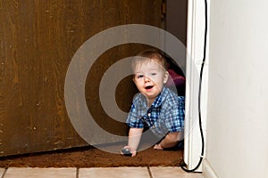 Baby Boy Crawls Through Doorway with a Smile