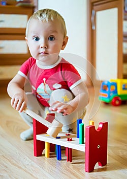 Baby boy with developing toy at home