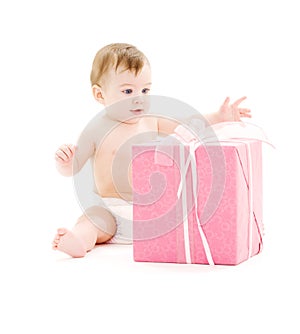Baby boy in diaper with big gift box