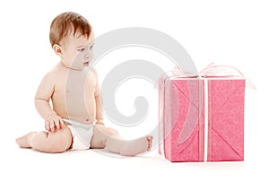 Baby boy in diaper with big gift box