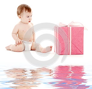 Baby boy in diaper with big gift box