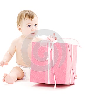 Baby boy in diaper with big gift box