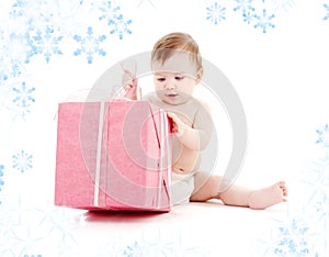 Baby boy in diaper with big gift box